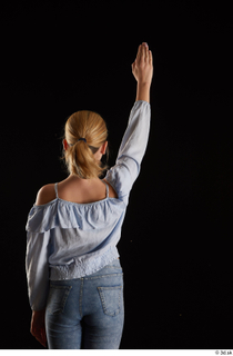 Sarah  1 arm back view blue blouse dressed flexing…